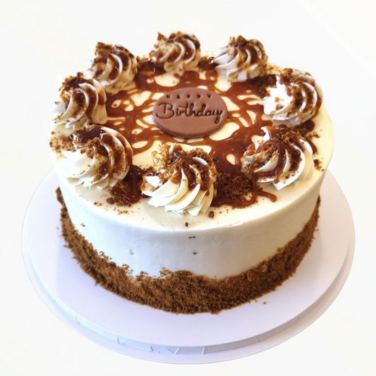 Birthday cake with white frosting, chocolate shavings, and a 'Happy Birthday' topper on a white background.